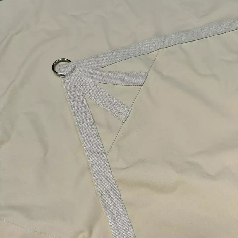 Storage tarpaulin/shade sail with metal rings